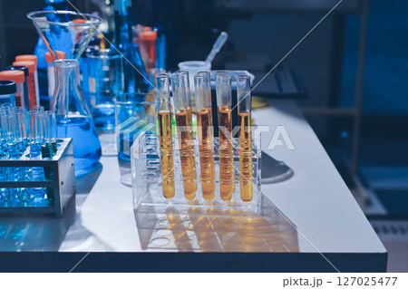 Scientist pipetting medical samples into microplate in laboratory 127025477