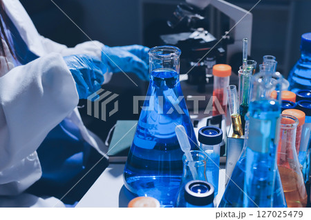 Scientist pipetting medical samples into microplate in laboratory Scientist pipetting medical samples into microplate in laboratory 127025479