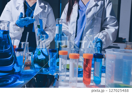 Scientist pipetting medical samples into microplate in laboratory Scientist pipetting medical samples into microplate in laboratory 127025488