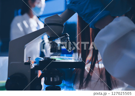Scientist pipetting medical samples into microplate in laboratory Scientist pipetting medical samples into microplate in laboratory 127025505