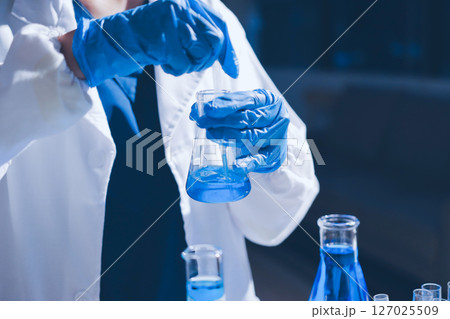 Scientist pipetting medical samples into microplate in laboratory Scientist pipetting medical samples into microplate in laboratory 127025509