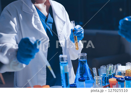Scientist pipetting medical samples into microplate in laboratory Scientist pipetting medical samples into microplate in laboratory 127025510