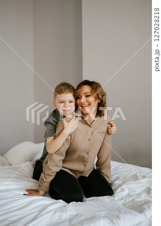 Mother and Son Sharing a Joyful Moment on Bed 127028218