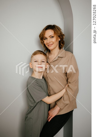 Mother and Son Sharing a Joyful Embrace Indoors Mother and Son Sharing a Joyful Embrace Indoors 127028268