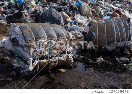 Debris and waste piled high at a landfill with compressed bales, emphasizing the urgency of proper waste disposal and environmental care Debris and waste piled high at a landfill with compressed bales, emphasizing the urgency of proper waste disposal and environmental care 127029478