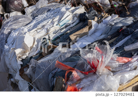 Various types of recyclable materials are stacked together at a waste management facility, showcasing the importance of recycling efforts 127029481