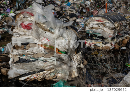 Mountains of trash and plastic debris create a serious pollution issue at a landfill site, highlighting waste management challenges Mountains of trash and plastic debris create a serious pollution issue at a landfill site, highlighting waste management challenges 127029652