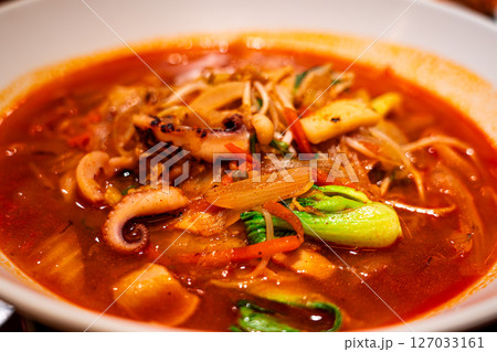 Jjamppong is a Korean noodle soup with red, spicy seafood Jjamppong is a Korean noodle soup with red, spicy seafood 127033161