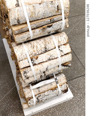 bundle firewood for sale at local market, perfect for winter warmth and cozy nights. closeup. 127036286