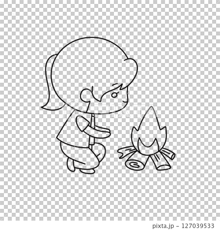 A girl is kneeling down next to a fire 127039533