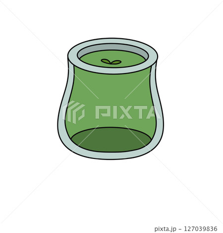 A green glass jar with a green apple inside 127039836