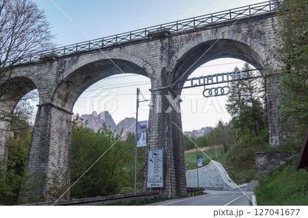 Cortina d Ampezzo, Italy , May 15 2025: Cortina Sign with Audi Logo looks like Olympic rings on the Viaduct at Dusk 127041677