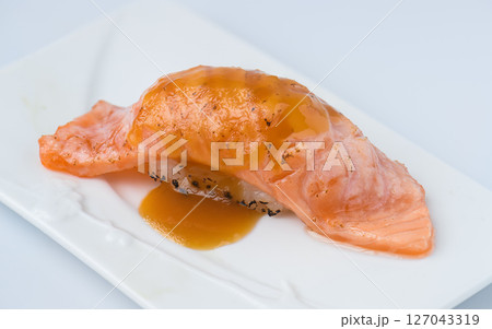 Salmon Nigiri Sushi with Sweet Soy Sauce on White Plate 127043319