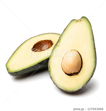 Healthy food and ingredients - Half of ripe organic green avocado fruit with pit isolated on white background with built-in clipping path Healthy food and ingredients - Half of ripe organic green avocado fruit with pit isolated on white background with built-in clipping path 127043888