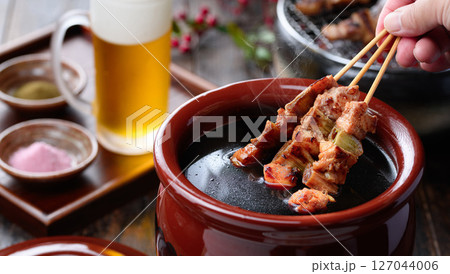 焼き鳥を秘伝のタレ壺にくぐらせるシズル感ある和風カット 127044006
