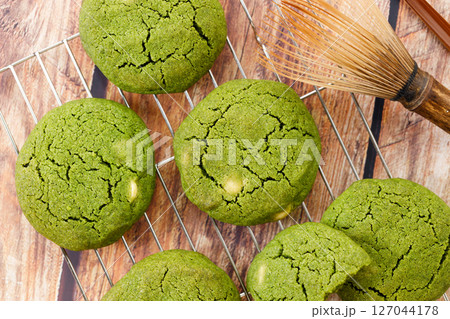 Chewy matcha chocolate chip cookies on cooling rack. 127044178