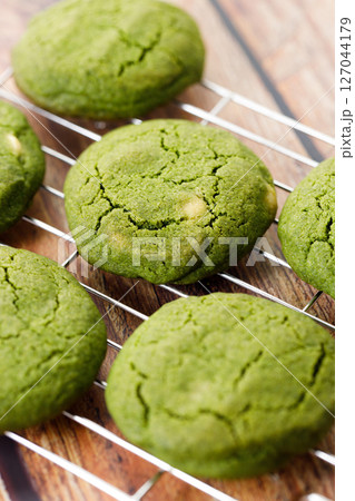 Chewy matcha chocolate chip cookies on cooling rack. 127044179