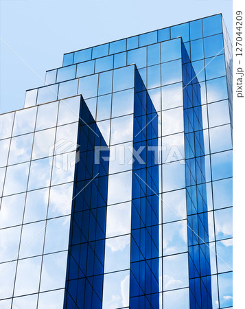 Modern building Glass facade Blue sky reflection Architecture details Modern building Glass facade Blue sky reflection Architecture details 127044209