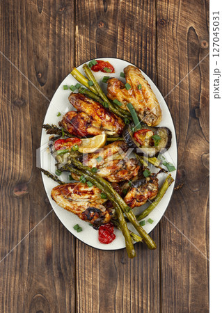Freshly baked chicken wings. Freshly baked chicken wings. 127045031