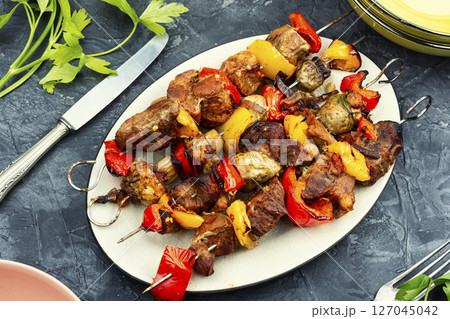 Skewers with grilled meat and vegetables. 127045042