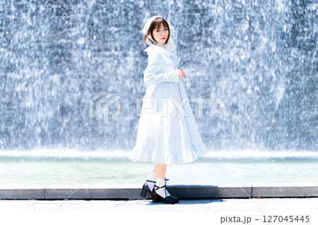 滝の前に立つクラシカルロリータファッションの女性 127045445