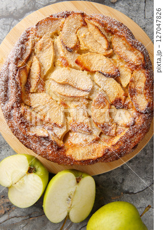 apple version of clafoutis a famous French dessert is flavored with cinnamon and vanilla close-up. vertical top view 127047826
