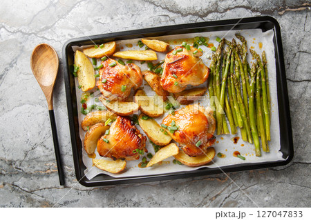Sheet pan chicken with asparagus and potatoes close-up. horizontal top view 127047833
