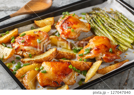 Sheet pan chicken with asparagus and potatoes close-up. horizontal 127047840