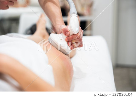 Client receiving professional treatment for skin rejuvenation in a spa 127050104