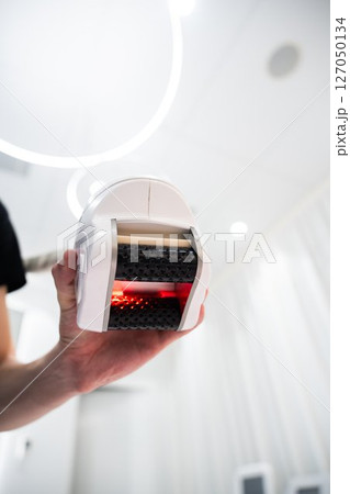 Handheld device for body therapy in modern wellness center 127050134