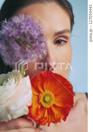 Woman holding colorful flowers, expressing beauty and creativity indoors Woman holding colorful flowers, expressing beauty and creativity indoors 127050442