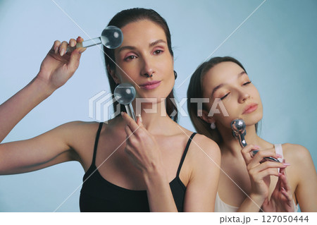 Beauty routine with facial rollers in a serene setting for relaxation Beauty routine with facial rollers in a serene setting for relaxation 127050444