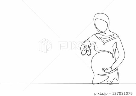 Single one line drawing small shoes for unborn baby in belly of pregnant woman. Arabian pregnant woman holding small baby shoes relaxing at home in bedroom. Continuous line draw design graphic vector 127051079