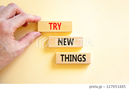 Try new things symbol. Concept words Try new things on beautiful wooden block. Businessman's hand. Beautiful white background. Business motivational lifestyle try new things concept. Copy space. 127051885