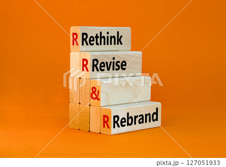 Rethink revise rebrand symbol. Concept word Rethink Revise and Rebrand on beautiful wooden blocks. Beautiful orange background. Business brand rethink revise rebrand concept. Copy space. 127051933