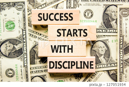 Success starts with discipline symbol. Concept words Success starts with discipline on beautiful wooden blocks. Beautiful dollar background. Business success starts with discipline concept. Copy space 127051934