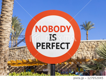 Nobody is perfect symbol. Concept words Nobody is perfect on beautiful white road sign. Beautiful palm tree hotel background. Business motivational lifestyle and nobody is perfect concept. Copy space. 127052045