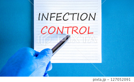 Infection control symbol. Concept words Infection control on beautiful white note. Doctor's hand in blue medical glove. Beautiful blue background. Medical healthy lifestyle infection control concept. Infection control symbol. Concept words Infection control on beautiful white note. Doctor's hand in blue medical glove. Beautiful blue background. Medical healthy lifestyle infection control concept. 127052091