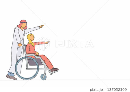 Single continuous line drawing happy Arabian wife have fun outdoor, pointing at park with husband. Caregiver man pushing woman on wheelchair, enjoy health care activity. One line graphic design vector 127052309