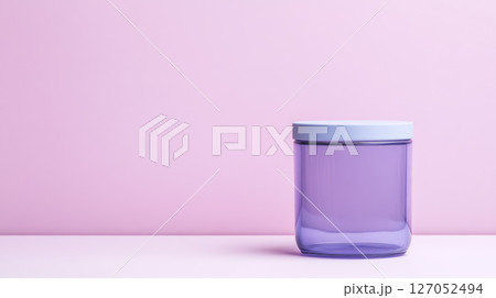 modern purple storage jar with light blue lid sits against soft pink background, adding touch of elegance to any space 127052494