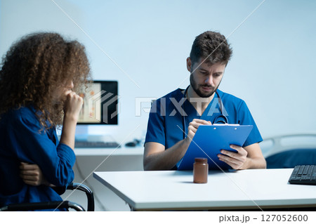 medicine, healthcare and people concept - doctor with tablet pc computer talking to woman patient at hospital. medicine, healthcare and people concept - doctor with tablet pc computer talking to woman patient at hospital. 127052600