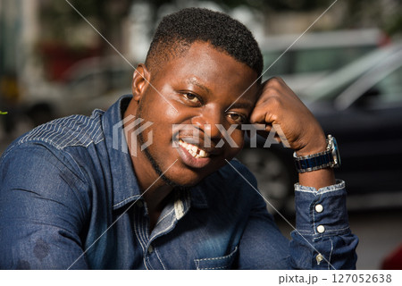 close up of young african man smiling. close up of young african man smiling. 127052638