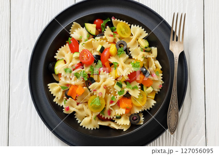salad of farfalle pasta with veggies and olives 127056095