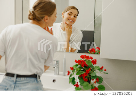 Embrace a Radiant Morning Skincare Routine within a Stylish and Modern Bathroom Setting Embrace a Radiant Morning Skincare Routine within a Stylish and Modern Bathroom Setting 127056205