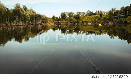 a small lake with trees in the background a small lake with trees in the background 127056299