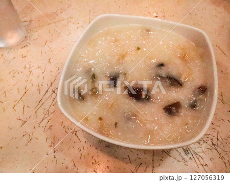 close up of Hong Kong Chinese congee with pork and century egg with copy space 127056319