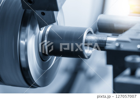 The multi tasking CNC lathe machine Swiss type bore cutting process the metal tube parts in the light blue scene. 127057007