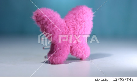 pink knitted hearts on blue background 127057845