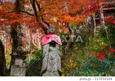 Buddha statue by colorful autumn leaf at Hasedera temple, Nara Buddha statue by colorful autumn leaf at Hasedera temple, Nara 127058109