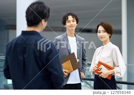 オフィスで打ち合わせする男女のビジネスチーム 127058140